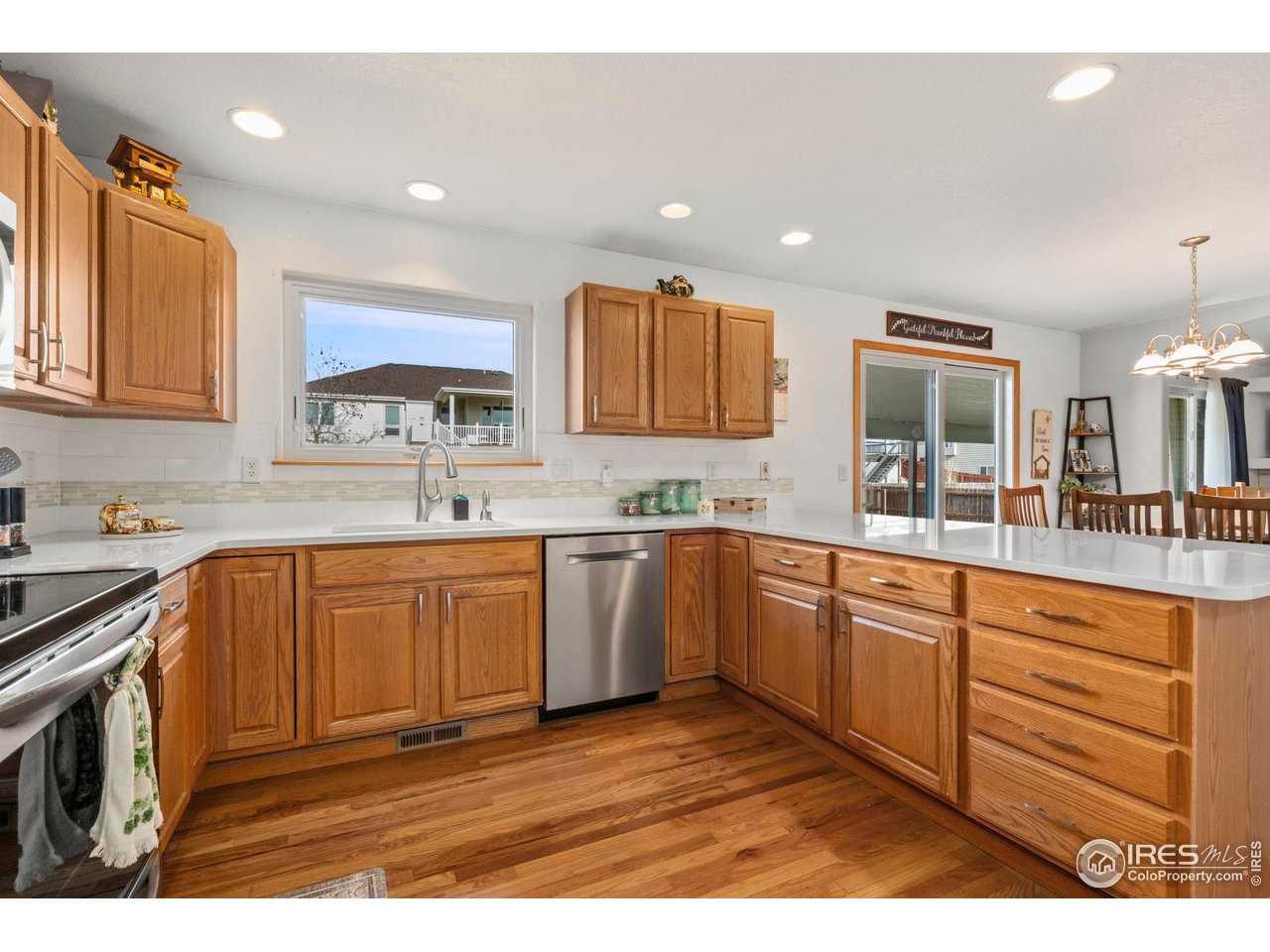 3012 54th Avenue Greeley, CO 80634 - Photo 13 of 33 a kitchen with stainless steel appliances granite countertop a sink stove and cabinets