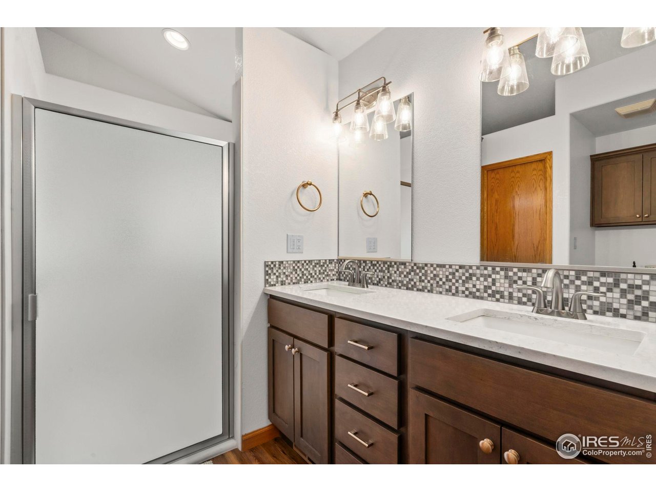 3012 54th Avenue Greeley, CO 80634 - Photo 17 of 33 a bathroom with a sink and a mirror