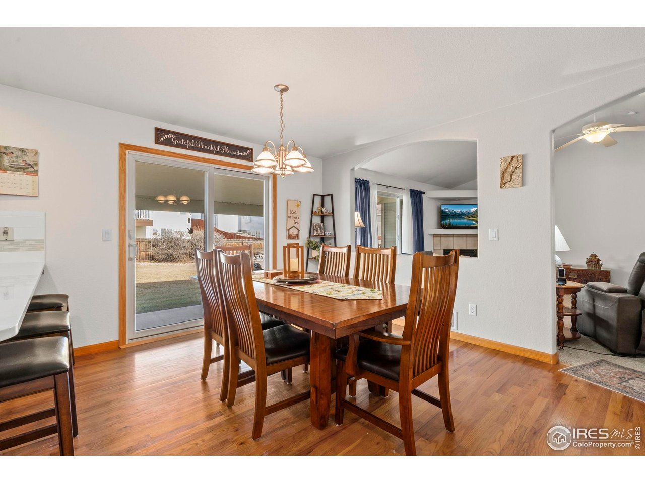 3012 54th Avenue Greeley, CO 80634 - Photo 10 of 33 a dining room with furniture a chandelier and wooden floor