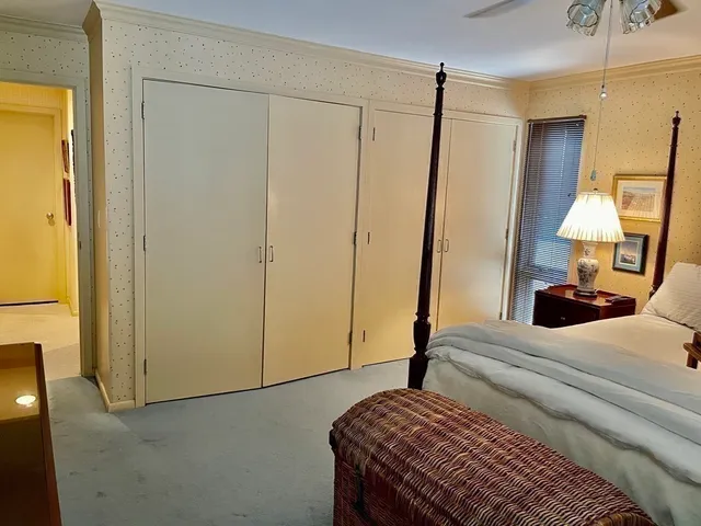a bedroom with a bed and a mirror