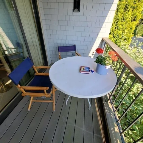 a view of a balcony with chairs
