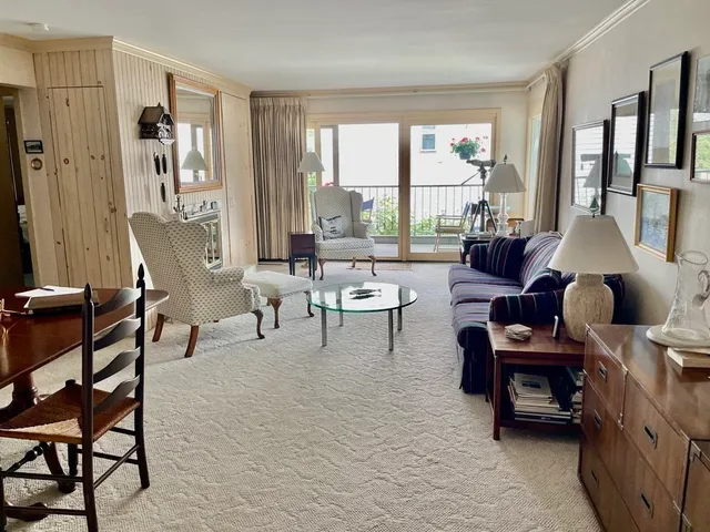 a living room with furniture and large windows