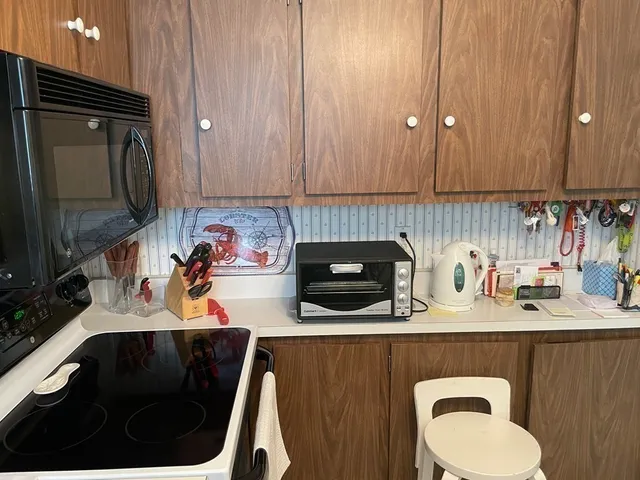 a kitchen with a sink a stove and a cabinets