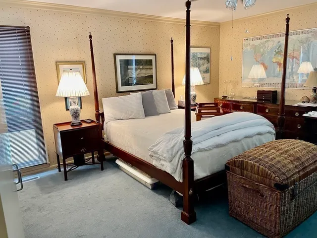 a bedroom with two beds and a dresser
