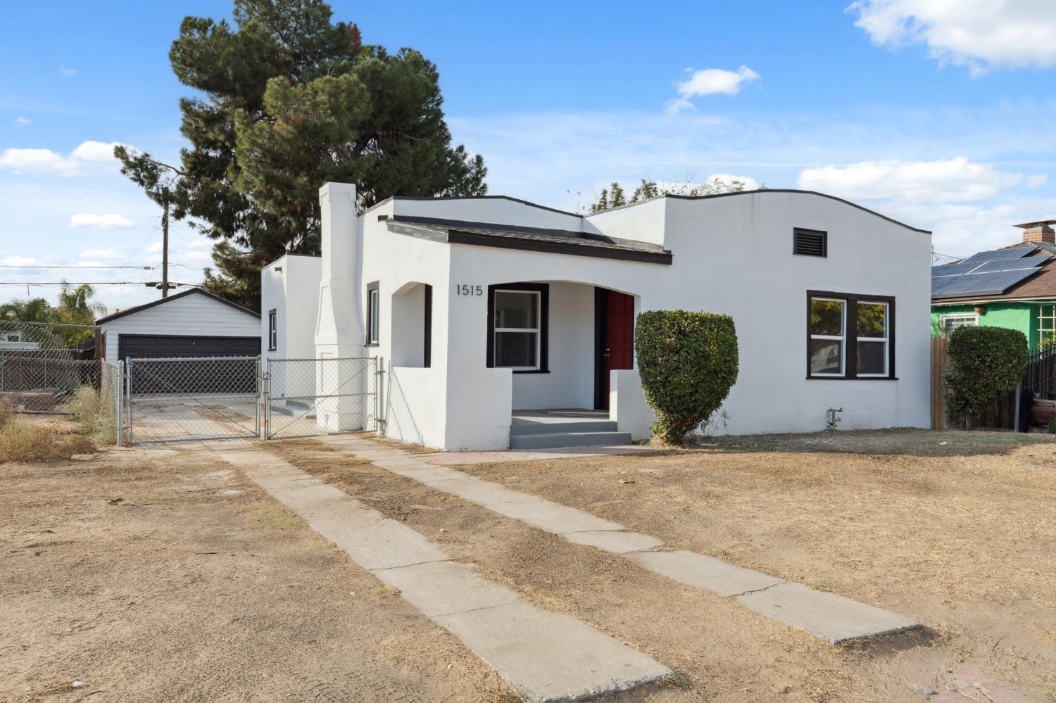 1515 North Fruit Avenue Fresno, CA 93728 - Photo 2 of 23 a front view of a house with a yard