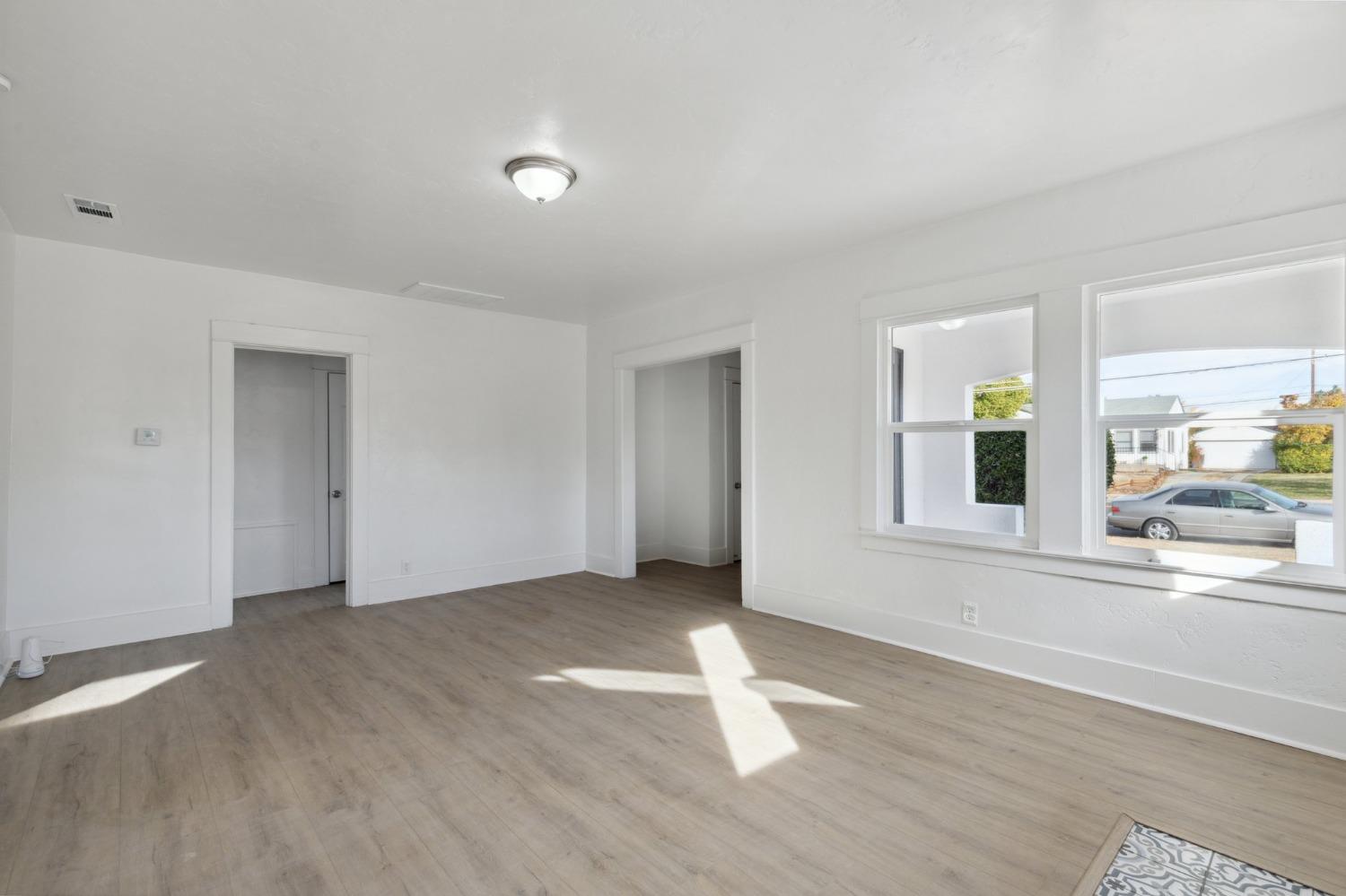 1515 North Fruit Avenue Fresno, CA 93728 - Photo 5 of 23 a view of empty room with wooden floor and fan