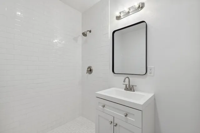 a bathroom with a sink a vanity and a mirror