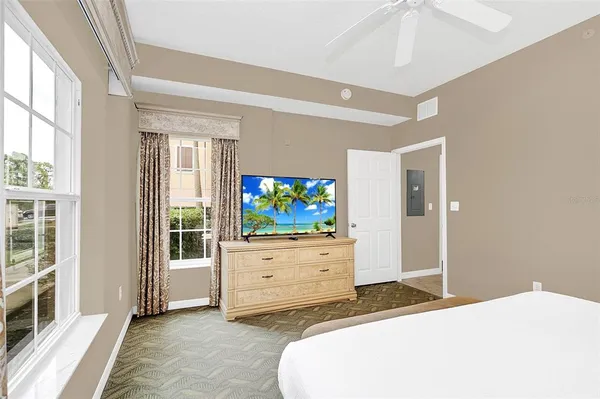 a bedroom with a bed and a flat screen tv