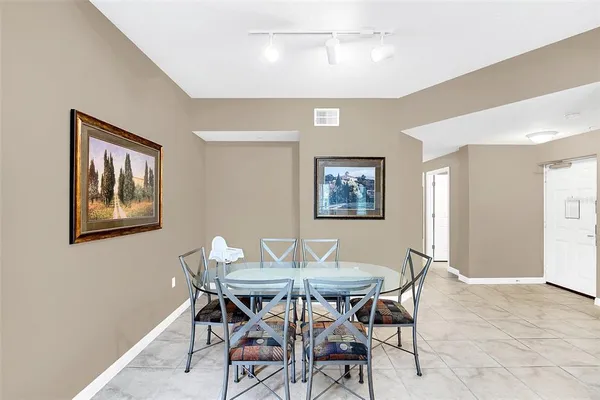 a view of a dining room with furniture and a chandelier fan