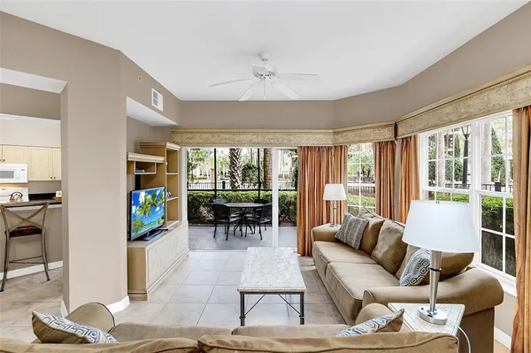 a living room with furniture and a potted plant