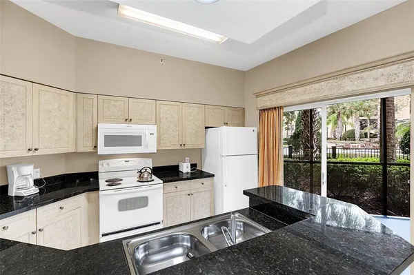a kitchen with stainless steel appliances a refrigerator sink and stove