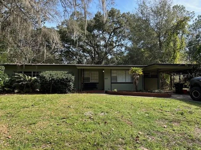 a view of a house with a yard and sitting area