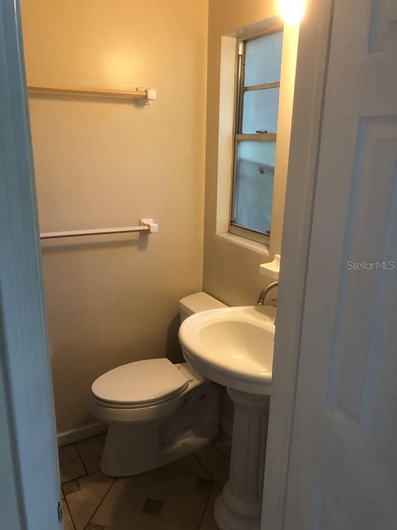 527 Northwest 36th Terrace Gainesville, FL 32607 - Photo 11 of 17 a white toilet sitting next to a bathroom sink