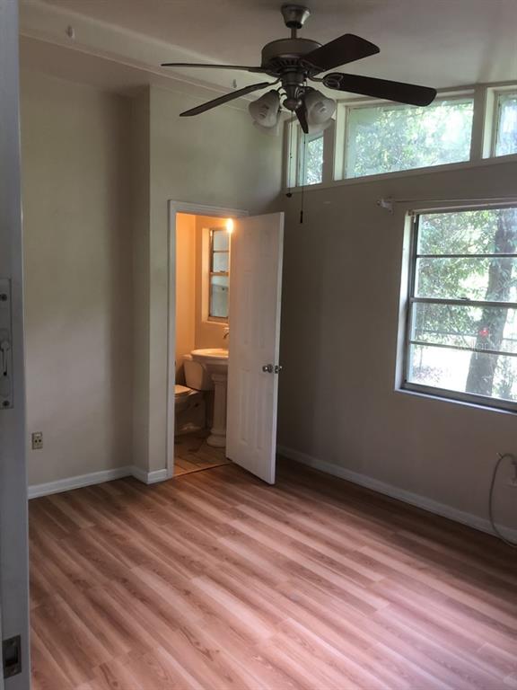 527 Northwest 36th Terrace Gainesville, FL 32607 - Photo 13 of 17 a view of a room with wooden floor and a window