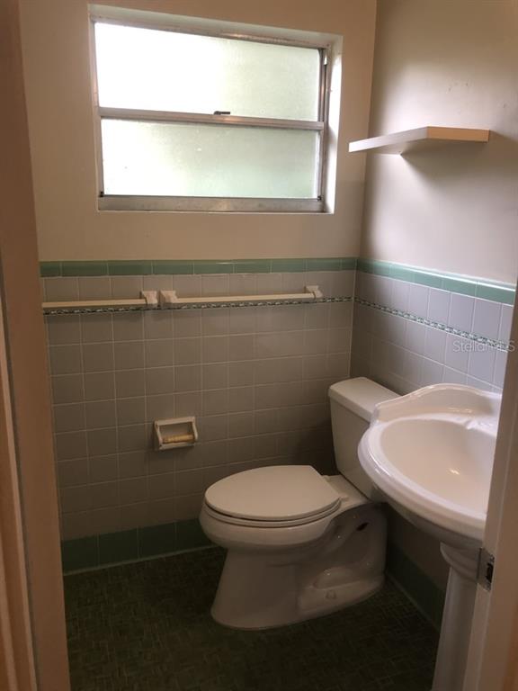 527 Northwest 36th Terrace Gainesville, FL 32607 - Photo 14 of 17 a bathroom with a toilet a sink and a window