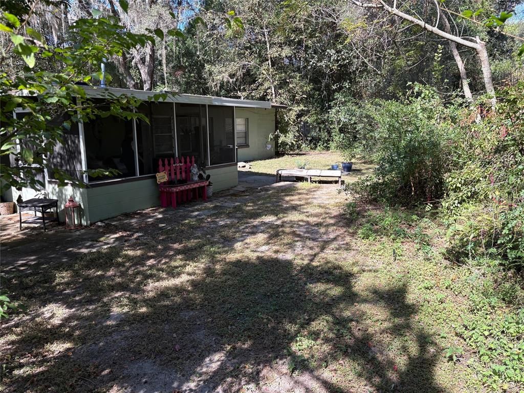 527 Northwest 36th Terrace Gainesville, FL 32607 - Photo 16 of 17 a view of a chair and table in the backyard of the house