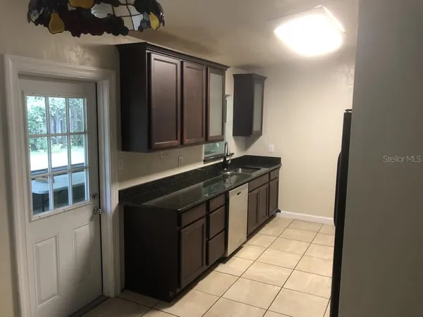 a kitchen with a sink and a refrigerator