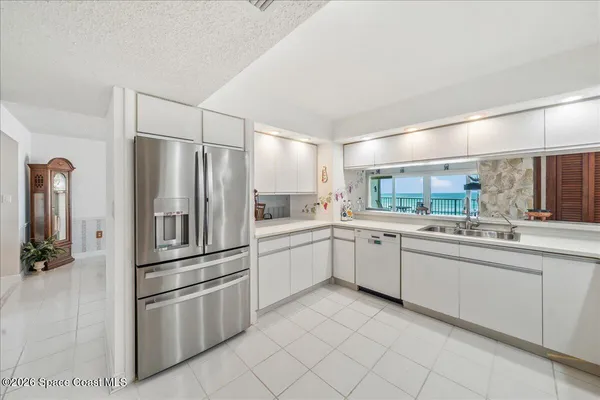 a kitchen with stainless steel appliances a refrigerator and a sink
