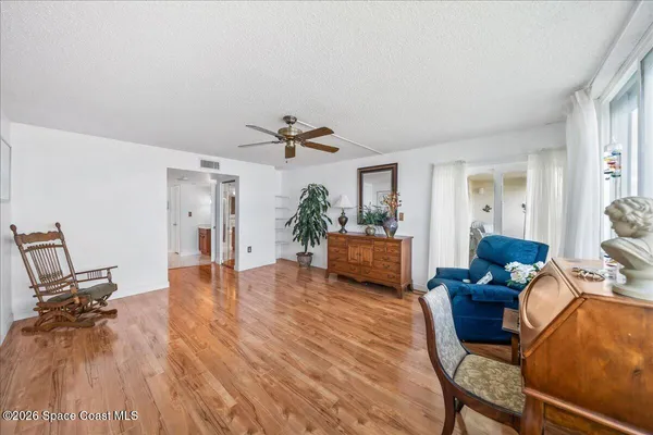 a bedroom with furniture and a wooden floor