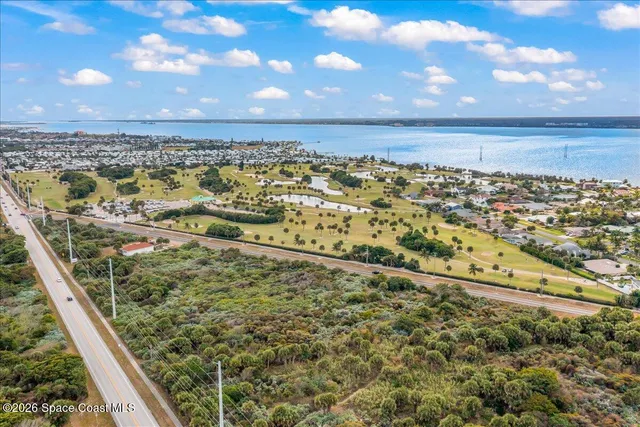 a view of a street with potted plants