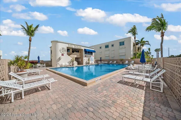 a view of a swimming pool with a table and chairs