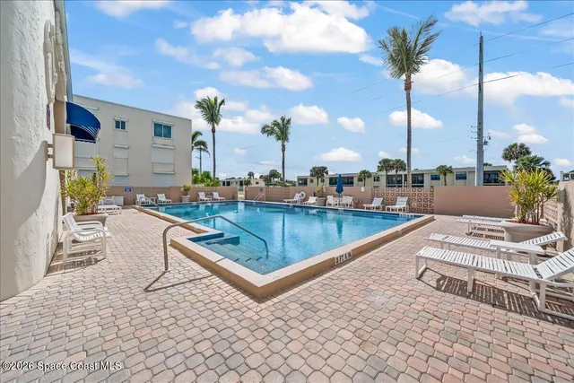 a view of a lake with houses in back