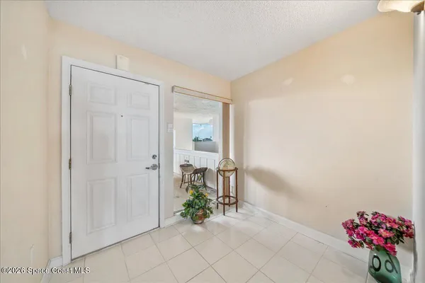a living room with furniture a fireplace and a floor to ceiling window