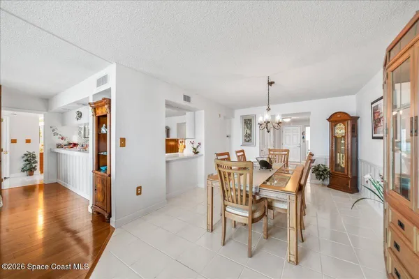 a living room with furniture large windows and wooden floor