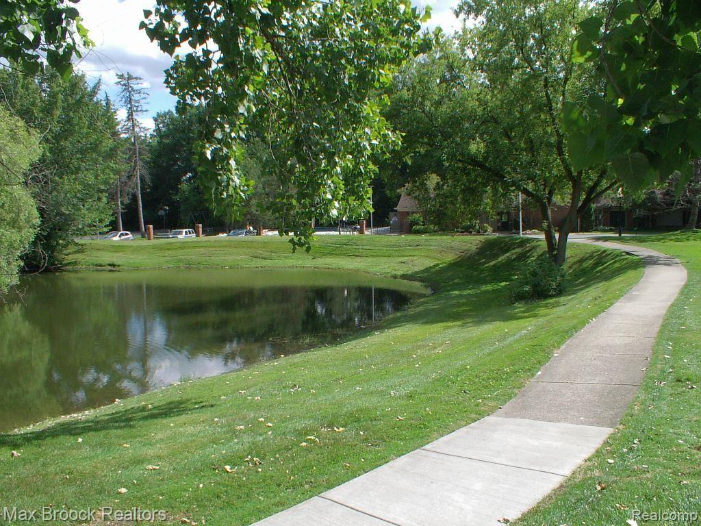 1197 Pine Ridge Court, Unit 129 Rochester, MI 48306 - Photo 9 of 23 Walkway to pool & clubhouse