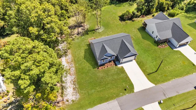 an aerial view of a house with swimming pool and garden