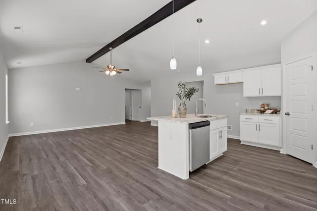 a kitchen with wooden floors and white appliances