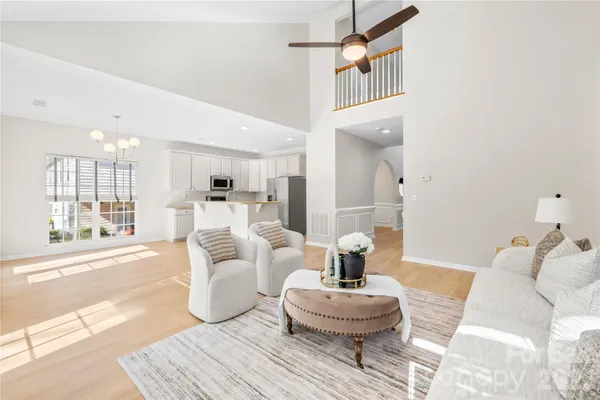 a living room with furniture a fireplace and a large window
