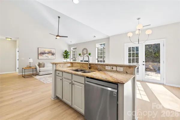 a kitchen with sink stove and cabinets