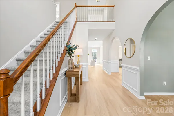 a view of entryway and hall with wooden floor