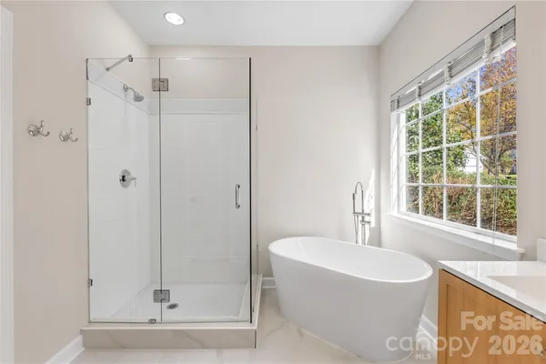 a bathroom with a bathtub and a shower
