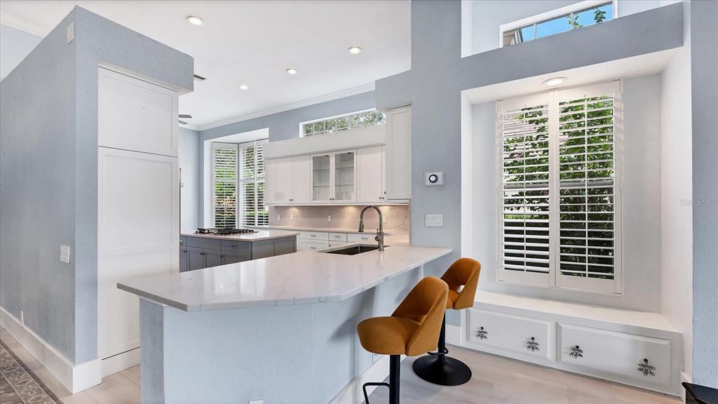 7217 Churston Lane University Park, FL 34201 - Photo 12 of 60 a kitchen with granite countertop kitchen island stainless steel appliances a sink and cabinets