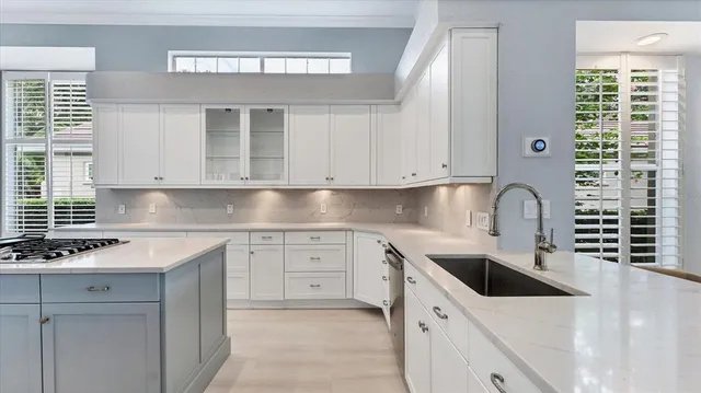 a kitchen with white cabinets and stainless steel appliances