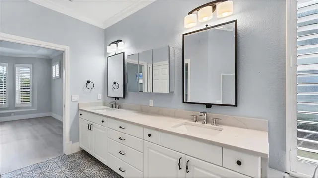 a bathroom with a granite countertop sink a mirror a bathtub and shower