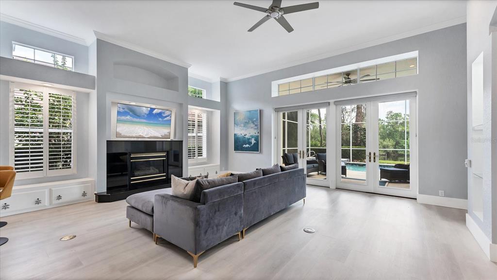 7217 Churston Lane University Park, FL 34201 - Photo 8 of 60 a living room with furniture a flat screen tv and a fireplace