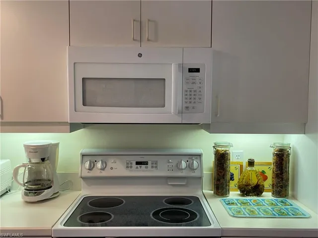 a kitchen with a stove and cabinets