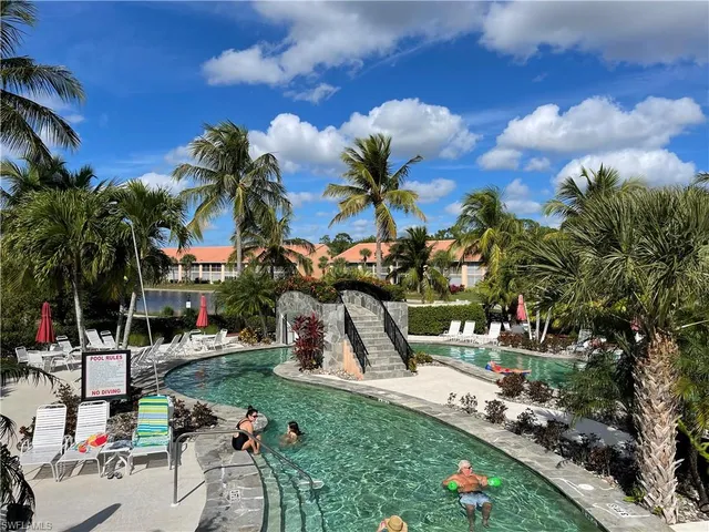 a dining room with wooden floor a chandelier a glass table and windows
