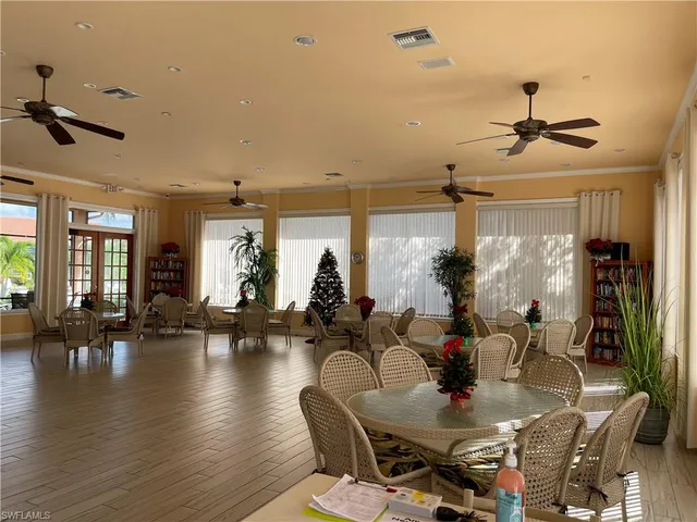a living room with furniture flat screen tv and a large window