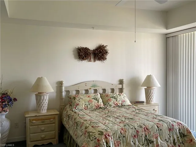 a bedroom with a bed and a night stand