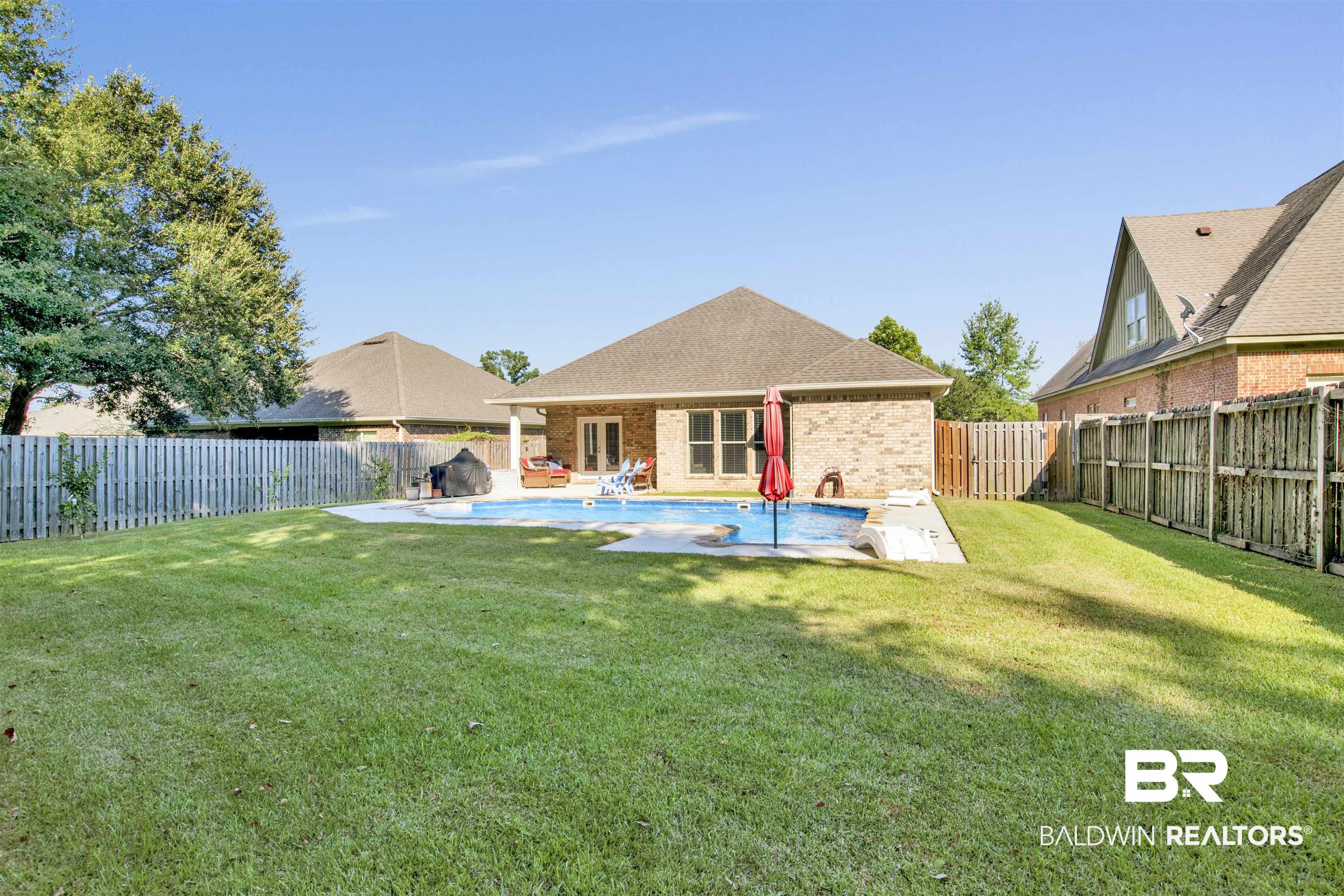 360 Scarlett Avenue Fairhope, AL 36532 - Photo 34 of 34 Rear view of property with a fenced in pool, a lawn, and a patio area