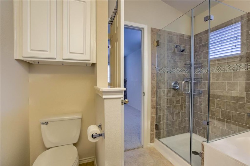1900 Scofield Ridge Parkway, Unit 4801 Austin, TX 78727 - Photo 10 of 15 a bathroom with a shower a toilet and sink