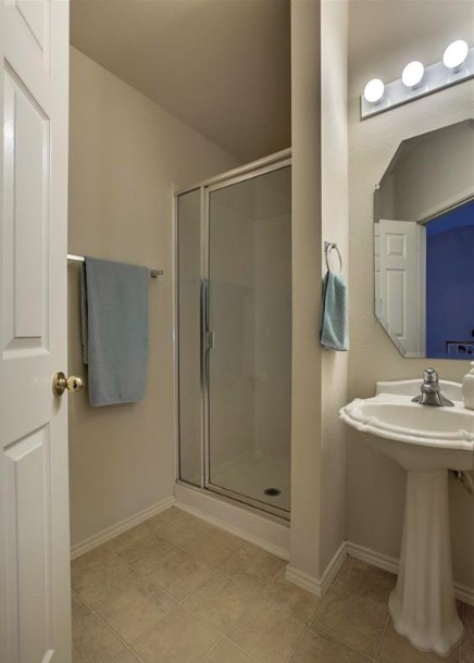 1900 Scofield Ridge Parkway, Unit 4801 Austin, TX 78727 - Photo 13 of 15 a bathroom with a sink mirror and shower