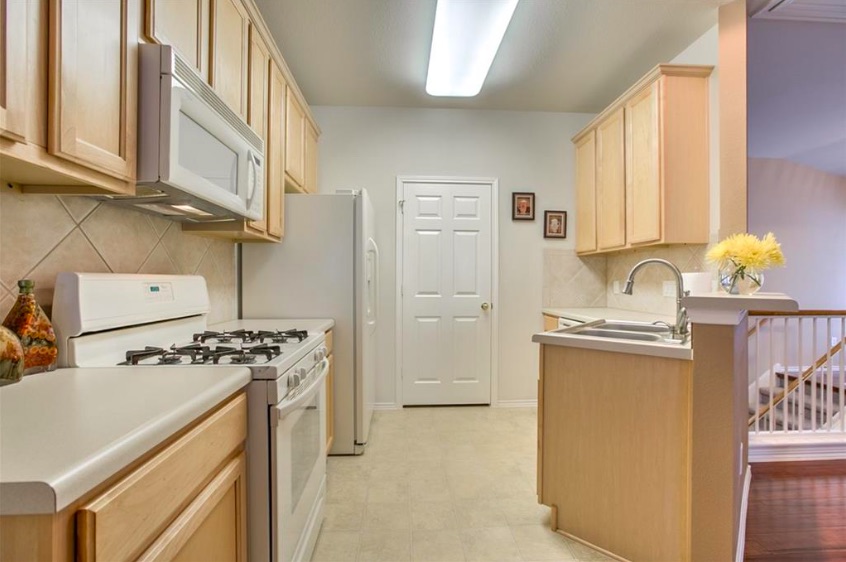 1900 Scofield Ridge Parkway, Unit 4801 Austin, TX 78727 - Photo 4 of 15 a kitchen with stainless steel appliances granite countertop a stove and a refrigerator