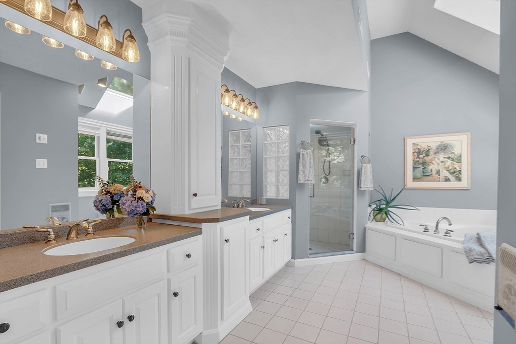 157 Lancaster Road North Andover, MA 01845 - Photo 26 of 42 a spacious en suite bathroom with a double vanity sink a mirror a bathtub and next to a window