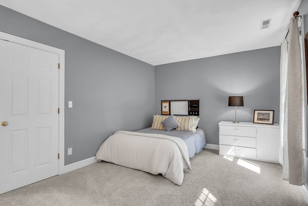 157 Lancaster Road North Andover, MA 01845 - Photo 31 of 42 a bedroom with a bed and white cabinets
