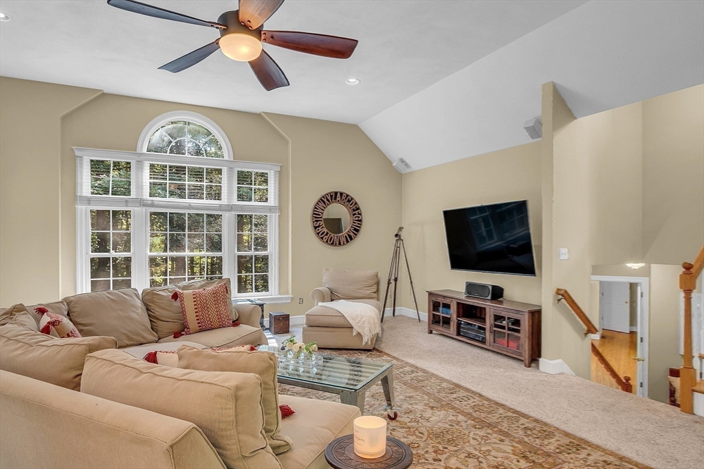 157 Lancaster Road North Andover, MA 01845 - Photo 33 of 42 a living room with furniture a ceiling fan and a flat screen tv